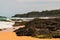 Waves Crash Over Exposed Coral Reef With Kilauea Lighthouse in The Distance