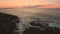 Waves Crash On Rocks Sunrise on Horizon on Atlantic Coast