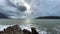 Waves crash on rocky cliff in Adriatic sea near mountains