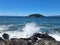 Waves crashing against rocks at Deception Pass park in summer