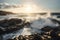 waves crashing against rocky coastline, with sunlit sky in the background