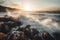 waves crashing against rocky coastline, with sunlit sky in the background