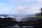 Waves crashing into the black volcanic shoreline at Waianapanapa State Park, Hana, Maui, Hawaii