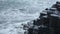 Waves crashing on the hexagon geological formations of Giant Causeway coastline, northern