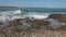 Waves crashing onto the rocks at the seashore