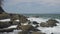 Waves crashing onto a rocky ocean shoreline