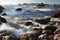 Waves crashing on rocky coastline of Asilomar State Marine Reserve in Pacific Grove, near 17 mile drive and Monterey, California