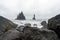 Waves crashing in on shore on Reynisfjara near the city of Vik in Iceland. Basalt Rocks raises from the sea