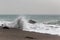 Waves crushing at the shore at sandy beach.