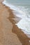 Waves from the English channel sea gently glide to and fro across the famous pebbled beach,during the late winter,Brighton,East