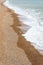 Waves from the English channel sea gently glide to and fro across the famous pebbled beach,during the late winter,Brighton,East