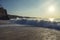 Waves foam at the beach. Mountains. Clear sky