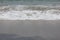 waves and foam of sea water with clear water on one of the beaches on the island of Lombok, Indonesia