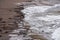 Waves forming drawings in the sand