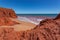 Waves at high tides breaking against the red pindan cliffs at James Price Point, Western Australia