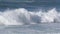 Waves hit surfer hard crashing along shoreline in Northern California at Big Sur Monterey area during tide