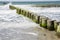 Waves hitting breakwater at beach