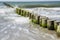 Waves hitting breakwater at beach