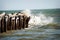 Waves hitting the pier at Sullivan Beach Island in Charleston, South Carolina.