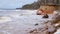 Waves hitting sandstone cliffs during a winter storm