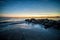 Waves and a jetty at sunset in the Atlantic Ocean at Edisto beach south carolina