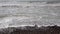 Waves lapping on the beach Worthing England closeup