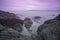 Waves of the ocean, sky and stones, boulders along the coastline