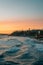 Waves in the Pacific Ocean and cliffs along the beach at sunset, in San Clemente, Orange County, California