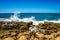 Waves of the Pacific Ocean crashing on the rocks on the shoreline of Ko Olina on the island of Oahu