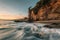 Waves in the Pacific Ocean and the Pirate Tower at sunset, at Victoria Beach, Laguna Beach, California