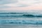 Waves in Pacific Ocean at sunset, in Newport Beach, Orange County, California