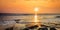 Waves and rocks on beach of sunset