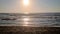 Waves roll ashore at sunset in the Mediterranean Sea