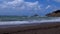 Waves roll on a deserted sandy beach. Stormy weather in Rhodes Greece Europe. Wide angle