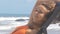 Waves Roll on Rocks Girl Rests in Chair on Beach Closeup