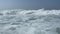 Waves of salty sea water on the beach at sea with splashes