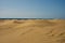 Waves sand dunes in desert with sea