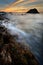 Waves splash on reef at sunrise