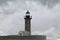 Waves splash and spray over lighthouse