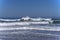 Waves splashing on huge rocks, off shore,