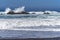 Waves splashing on huge rocks, off shore,