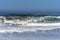 Waves splashing on huge rocks, off shore,