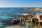 Waves splashing rocks at Bay of Fires in Tasmania, rocky coastline in Australia.