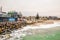 Waves, stones at the coastline with houses in background, Swakopmund German colonial town, Namibia