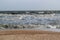 Waves during a storm at sea. in the distance you can see large ships and barges