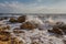 Waves stumble across rocks on the coast