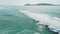 Waves and surfers in ocean. Aerial view of surf spot in Florianopolis