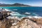 Waves washing onto rocks near Algajola beach in Corsica