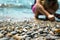 Waves washing over gravel beach and playing kid