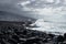 Waves at the wavebreakers along black lava stone coastline at Puerto de la Cruz, Tenerife, Canary Islands, Spain